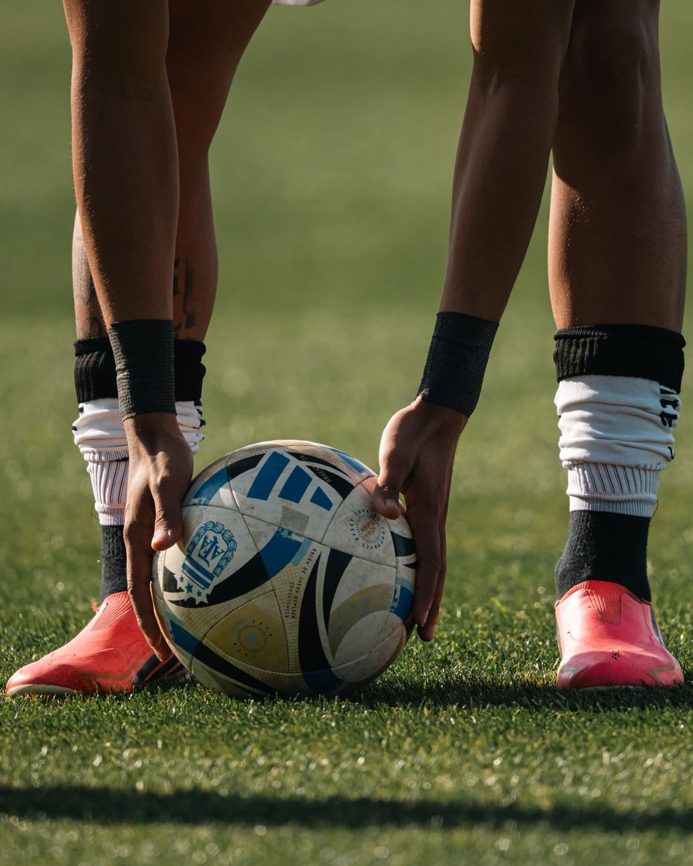A footballer placing the ball at golden hour