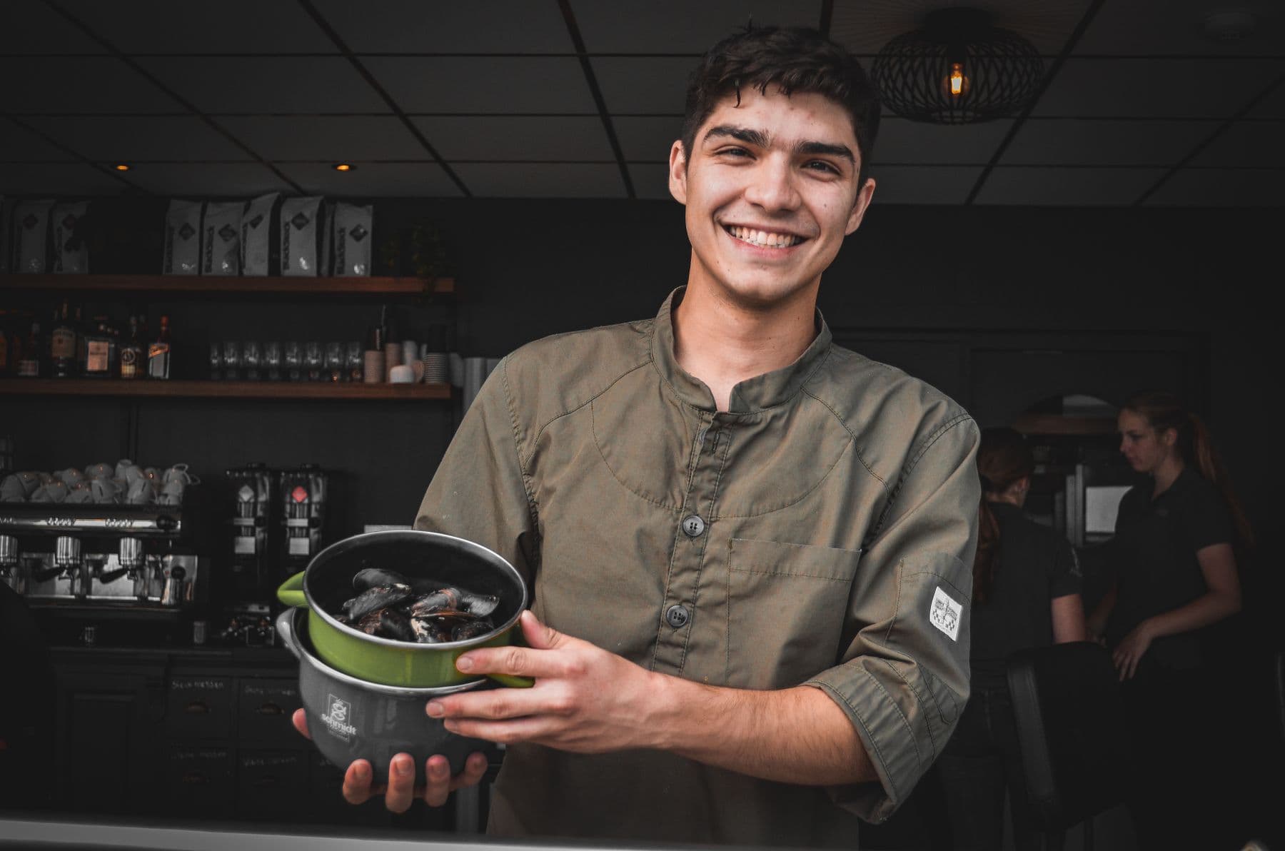 Chef smiling while presenting a finished dish